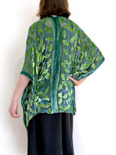 Load image into Gallery viewer, modeling green gingko leaf modeling the back of a  devoré or burnout velvet kimono jacket that is hand painted Gingko Leaves. Worn over back dress.