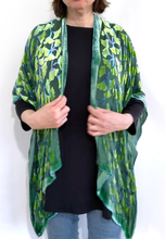 Load image into Gallery viewer, modeling the back of a  devoré or burnout velvet kimono jacket that is hand painted Gingko Leaves. Worn over back shirt and jeans.
